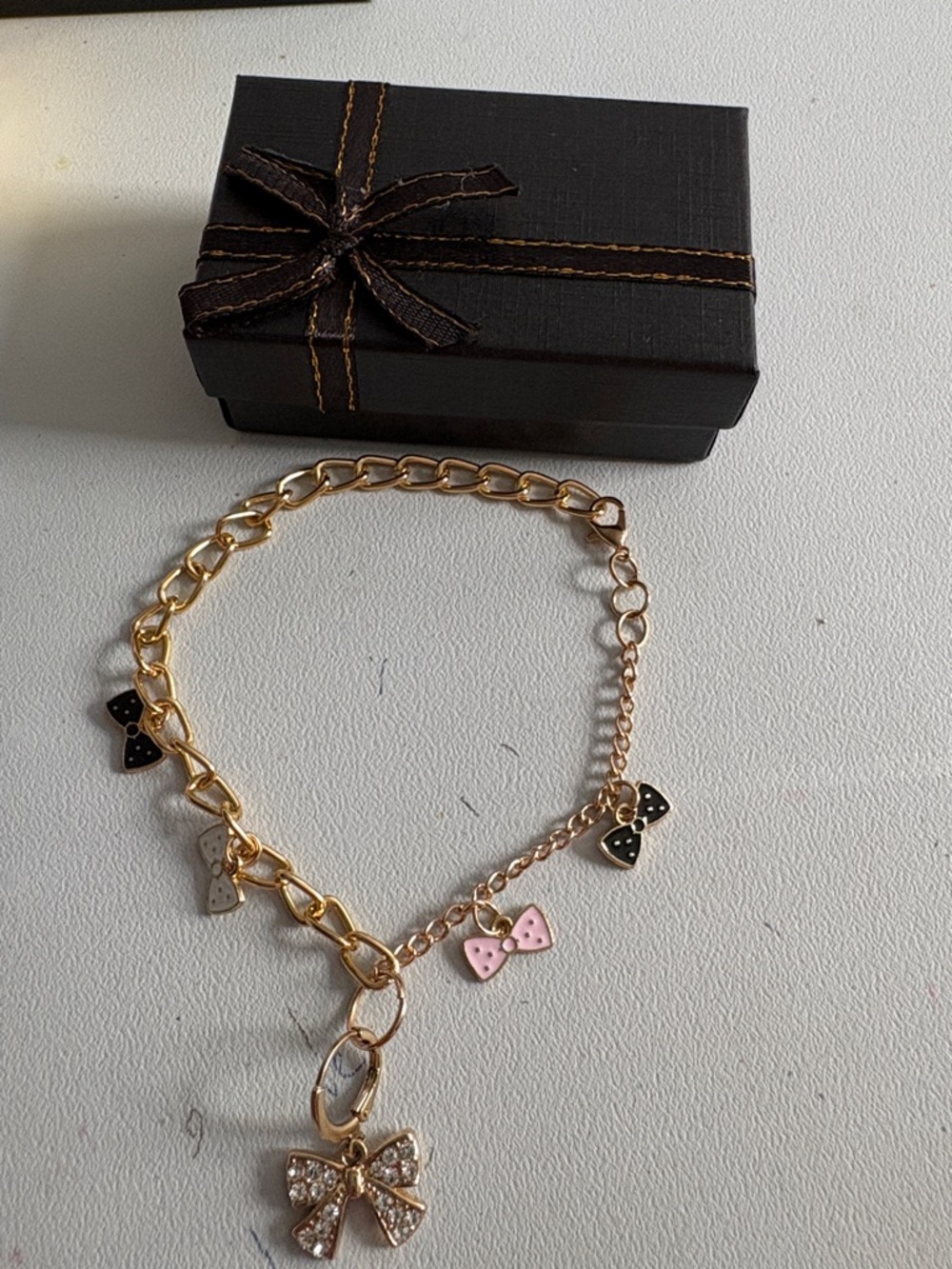 Hand Crafted Gold Bracelet with Pink, Black & White Bow Charms